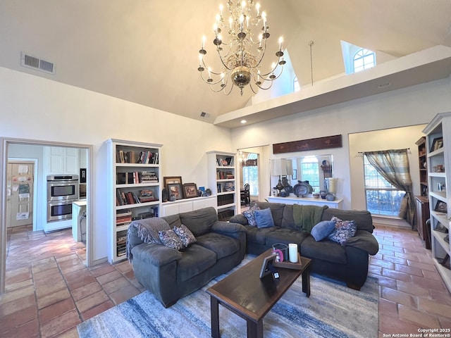 living room featuring a notable chandelier and a towering ceiling