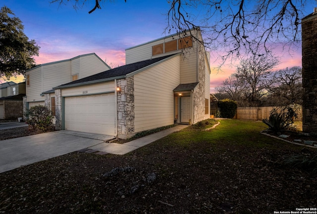 exterior space with a garage and a lawn