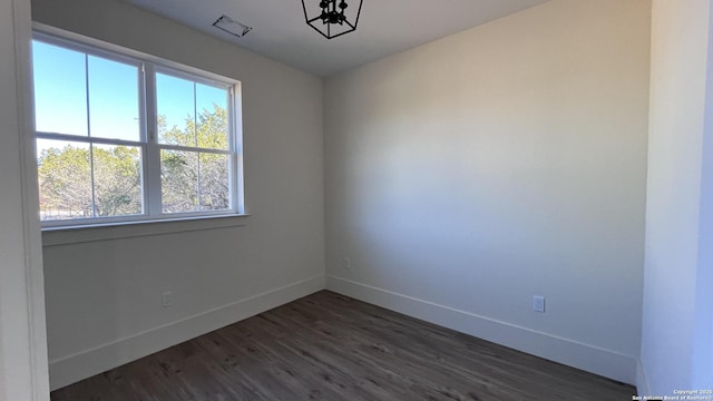 empty room with dark wood-type flooring