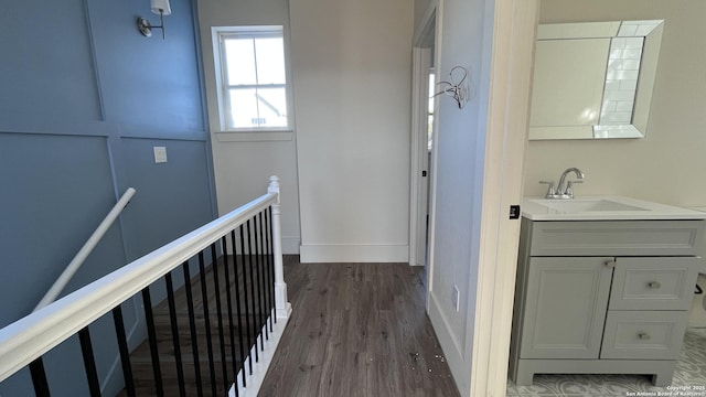 hallway featuring dark hardwood / wood-style flooring and sink