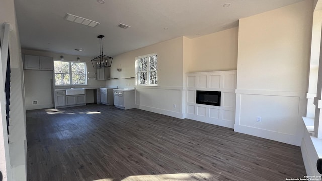 unfurnished living room with dark hardwood / wood-style floors