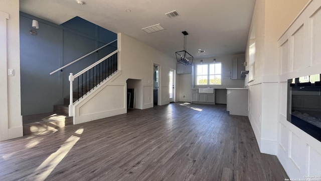 unfurnished living room with sink and dark hardwood / wood-style flooring