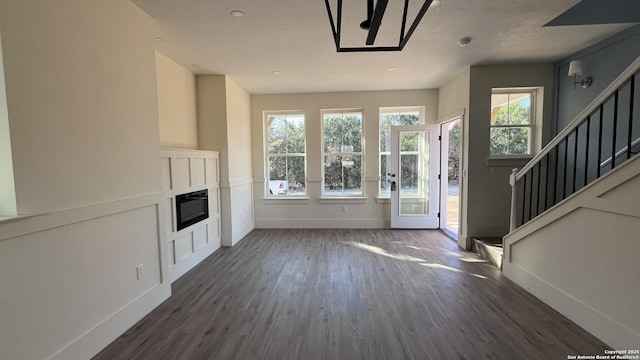 unfurnished living room featuring dark wood-type flooring