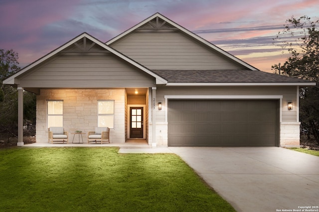 view of front of house featuring a garage and a lawn