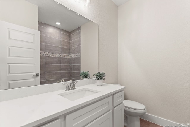 bathroom featuring vanity, wood-type flooring, and toilet