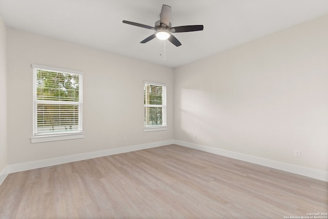 empty room with ceiling fan and light hardwood / wood-style flooring