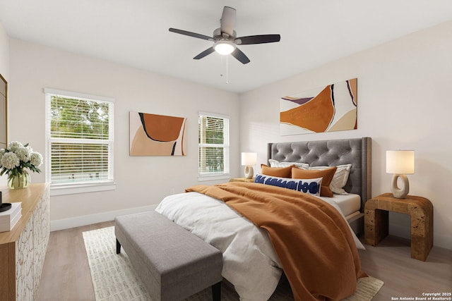 bedroom with light hardwood / wood-style flooring and ceiling fan