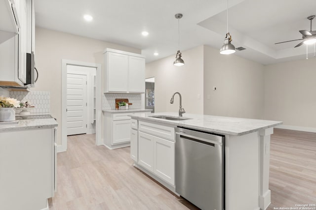 kitchen with an island with sink, appliances with stainless steel finishes, sink, and white cabinets