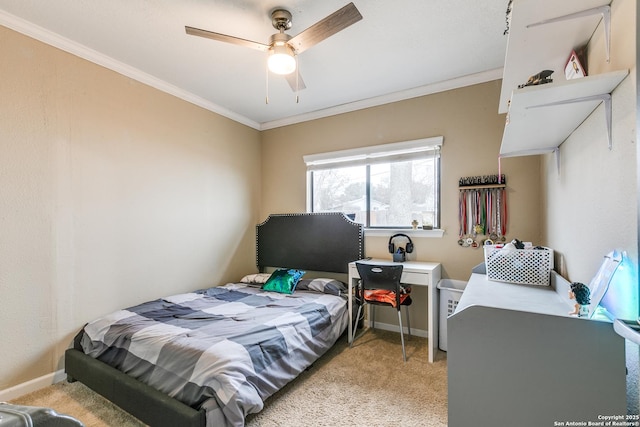 carpeted bedroom featuring crown molding and ceiling fan