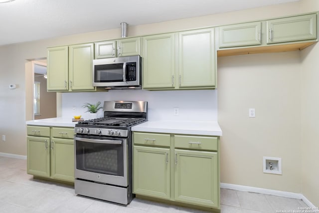 kitchen featuring light tile patterned floors, green cabinetry, and appliances with stainless steel finishes