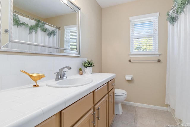 bathroom featuring vanity, decorative backsplash, tile patterned floors, and toilet