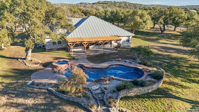 view of pool featuring a lawn