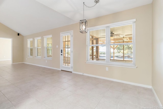 unfurnished room with vaulted ceiling and light tile patterned flooring