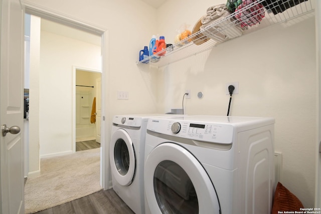 clothes washing area featuring dark hardwood / wood-style floors and independent washer and dryer