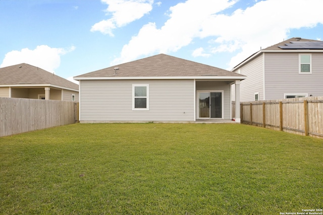 back of house featuring a lawn