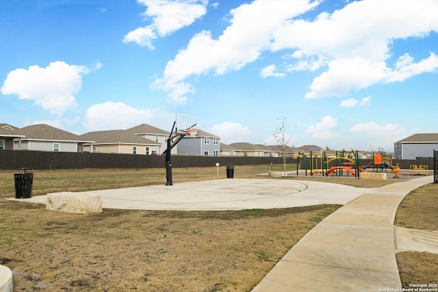 view of sport court featuring a playground and a lawn