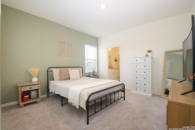 carpeted bedroom featuring connected bathroom