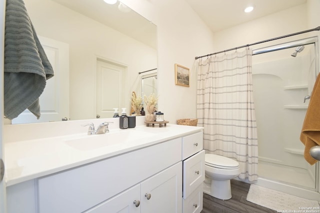 bathroom with vanity, hardwood / wood-style flooring, and walk in shower