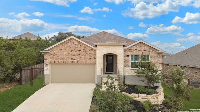 view of front of house featuring a garage and a front lawn