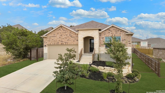 view of front of home featuring a garage and a front lawn