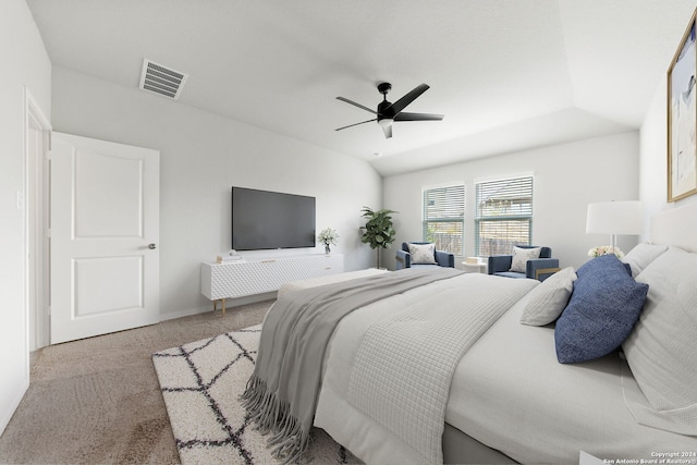 bedroom with ceiling fan, light colored carpet, and vaulted ceiling