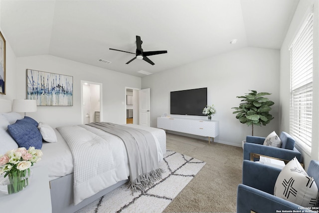 carpeted bedroom with lofted ceiling, connected bathroom, and ceiling fan