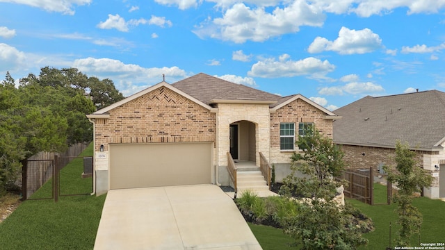 view of front of home with a garage and a front lawn