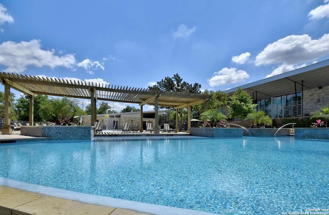 view of pool with a pergola and pool water feature