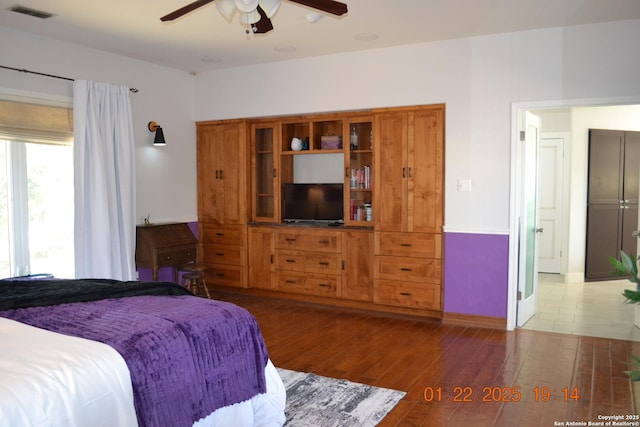 bedroom featuring dark hardwood / wood-style flooring and ceiling fan