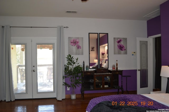 bedroom with access to exterior, hardwood / wood-style floors, and french doors