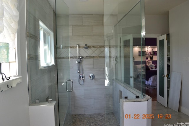 bathroom featuring a shower with door and tile patterned floors