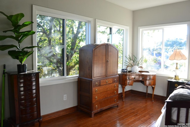 bedroom with dark wood-type flooring