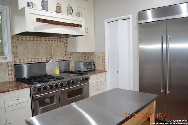 kitchen featuring white cabinetry, appliances with stainless steel finishes, and backsplash