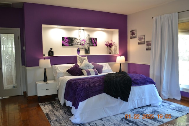 bedroom featuring wood-type flooring and multiple windows