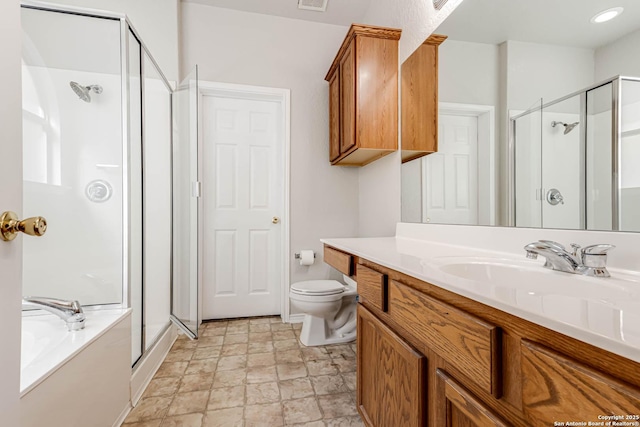 full bathroom featuring shower with separate bathtub, vanity, and toilet