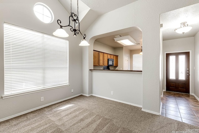 interior space with lofted ceiling and a textured ceiling