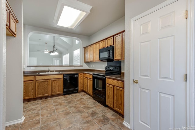 kitchen featuring lofted ceiling, sink, ceiling fan, black appliances, and decorative light fixtures