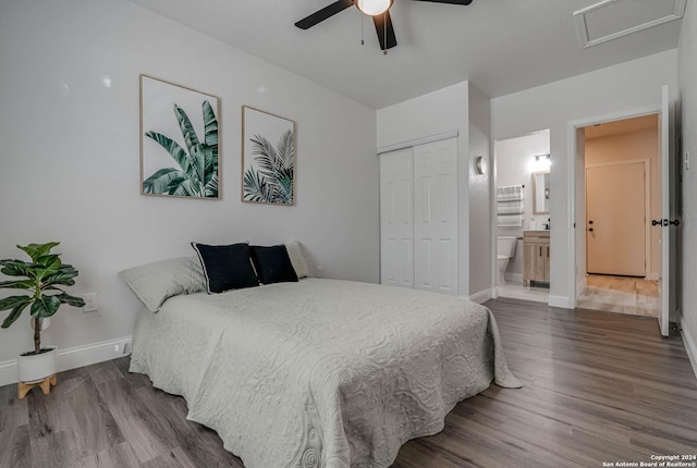 bedroom with hardwood / wood-style flooring, a closet, ceiling fan, and ensuite bathroom