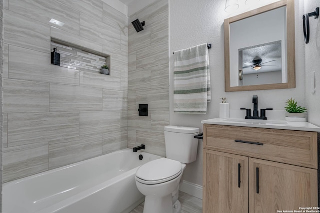 full bathroom featuring tiled shower / bath combo, vanity, and toilet