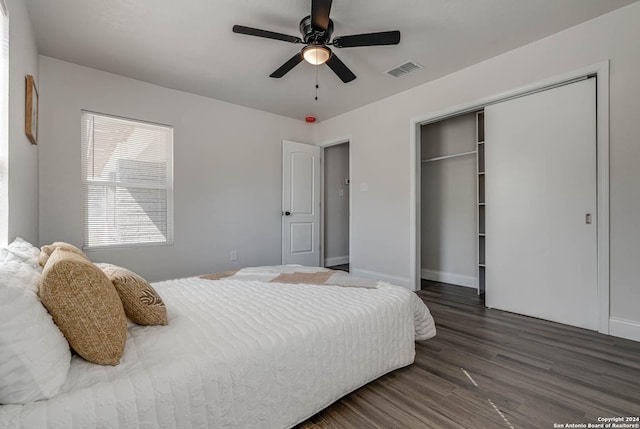 bedroom with ceiling fan, dark hardwood / wood-style floors, and a closet