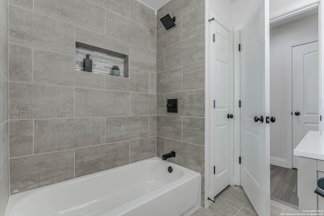 bathroom featuring tiled shower / bath combo and tile patterned flooring