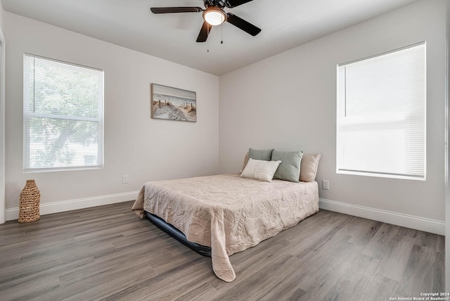 bedroom with wood-type flooring and ceiling fan