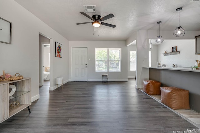 entrance foyer featuring dark wood-type flooring, ceiling fan, and a textured ceiling