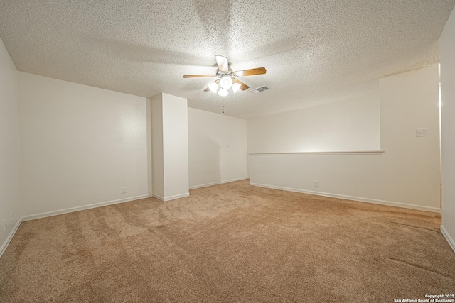 empty room with carpet, a textured ceiling, and ceiling fan