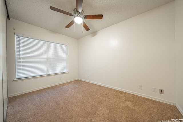 unfurnished room featuring ceiling fan, light colored carpet, and a textured ceiling