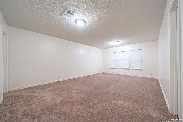 unfurnished room featuring carpet floors and a textured ceiling