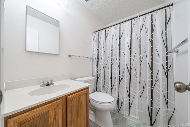 bathroom with vanity, walk in shower, a textured ceiling, and toilet