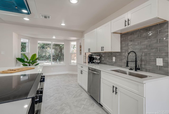 kitchen featuring a healthy amount of sunlight, sink, white cabinets, and dishwasher