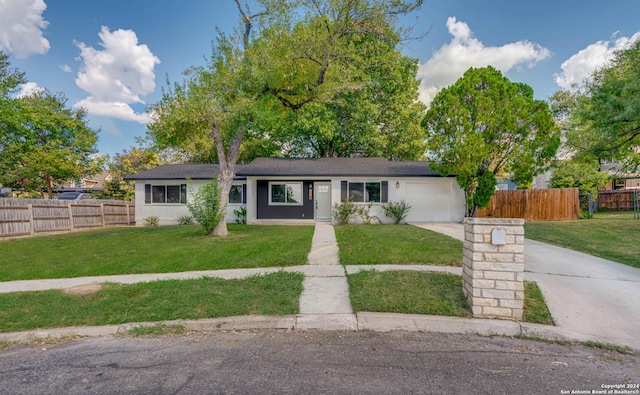 ranch-style house with a garage and a front yard