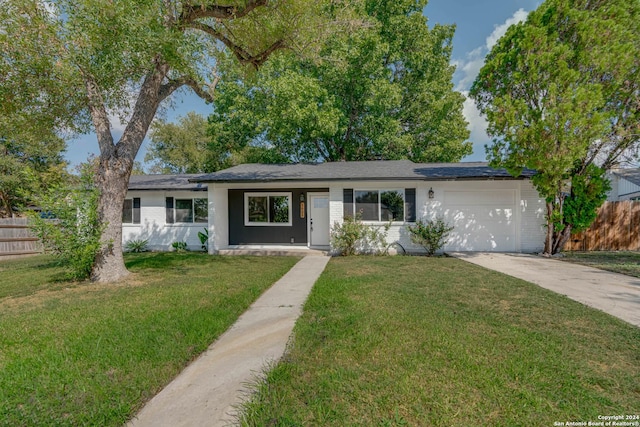 single story home with a garage and a front yard